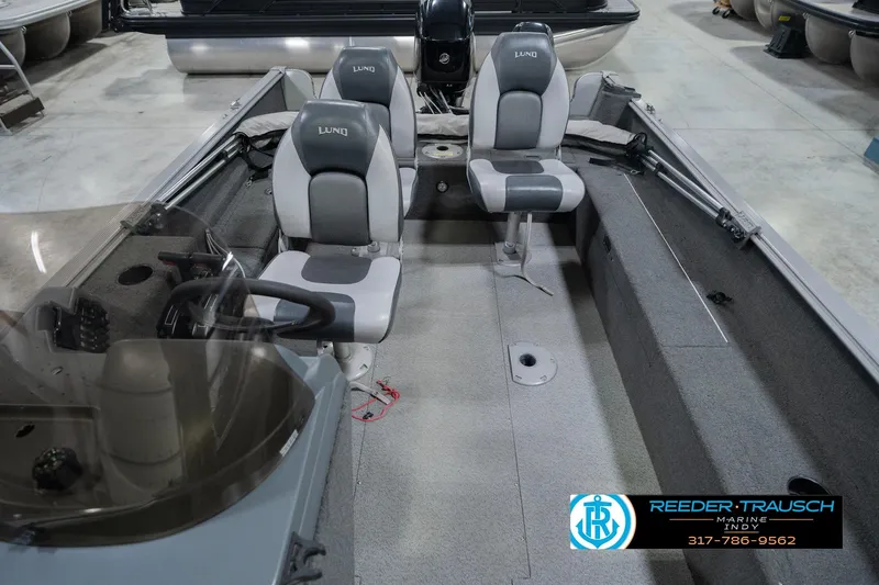 Slide: The Image of 2013 Lund 1650 Rebel XL Sport boat interior with seating and steering console. - 20