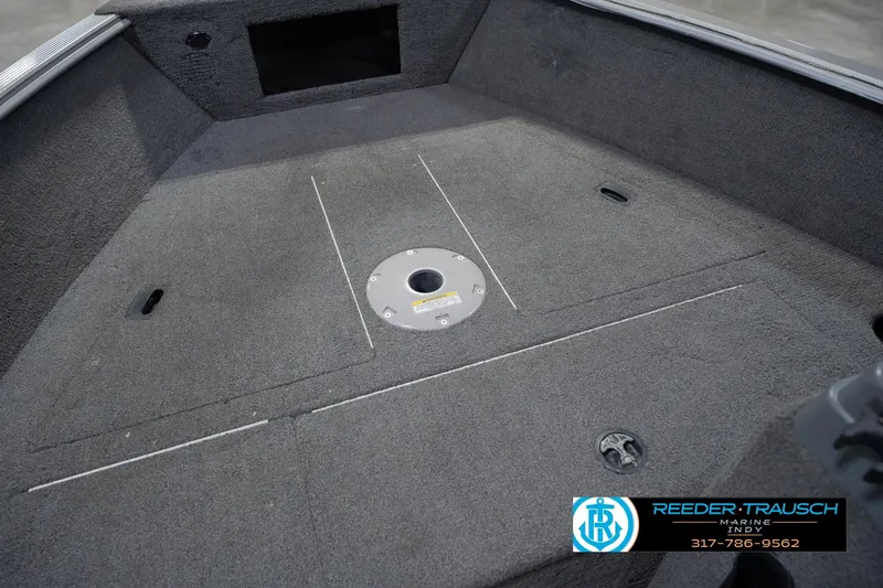 Slide: The Image of 2013 Lund 1650 Rebel XL Sport boat interior with carpeted deck and storage compartments. - 22