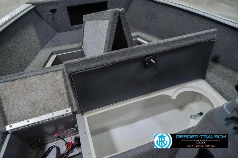 Slide: The Image of Interior view of a 2013 Lund 1650 Rebel XL Sport boat, showcasing storage compartments. - 23