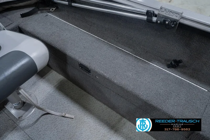 Slide: The Image of Interior of 2013 Lund 1650 Rebel XL Sport boat with seating and carpeted flooring. - 24