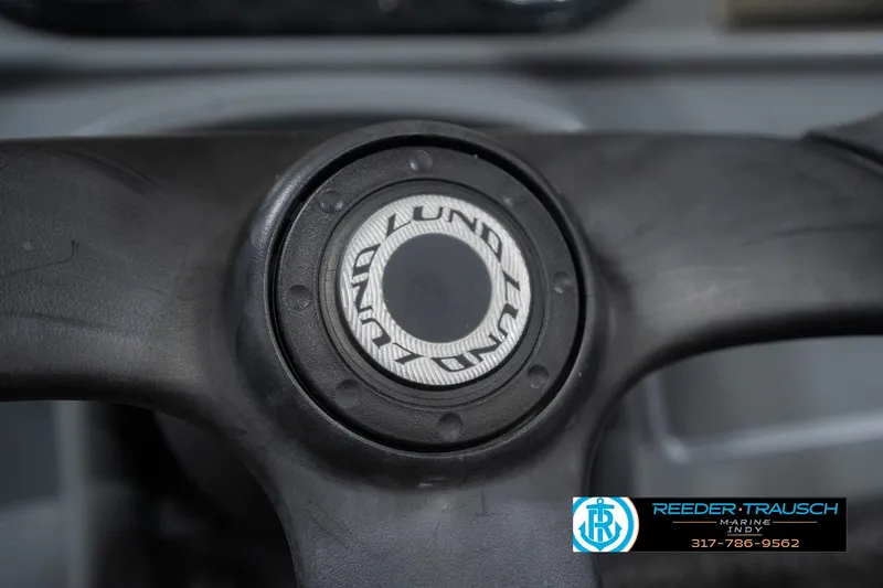 Slide: The Image of Steering wheel of 2013 Lund 1650 Rebel XL Sport boat, featuring Lund logo. - 28