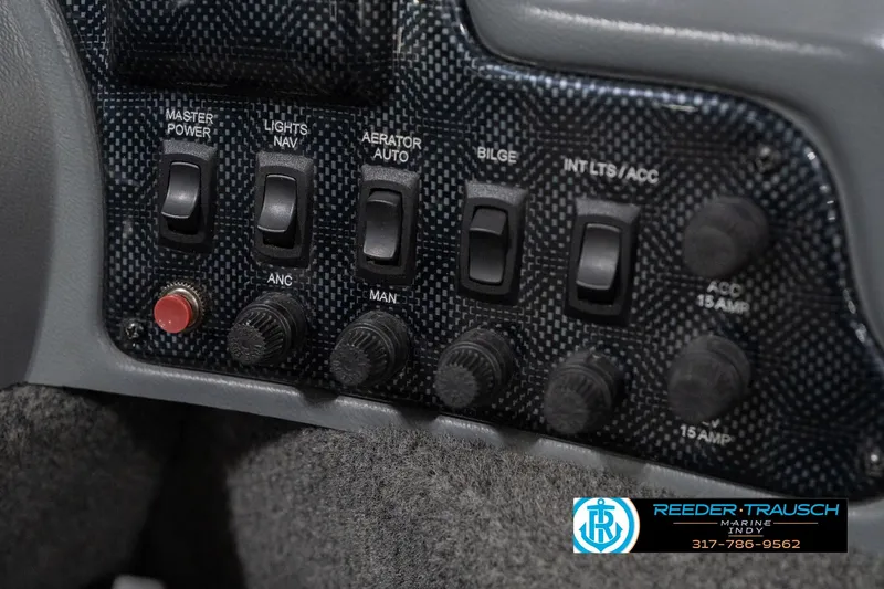 Slide: The Image of Control panel of a 2013 Lund 1650 Rebel XL Sport boat with various switches. - 30