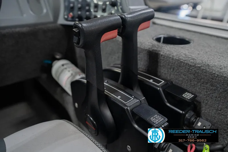 Slide: The Image of Close-up of 2013 Lund 1650 Rebel XL Sport boat controls with dual throttle levers. - 31