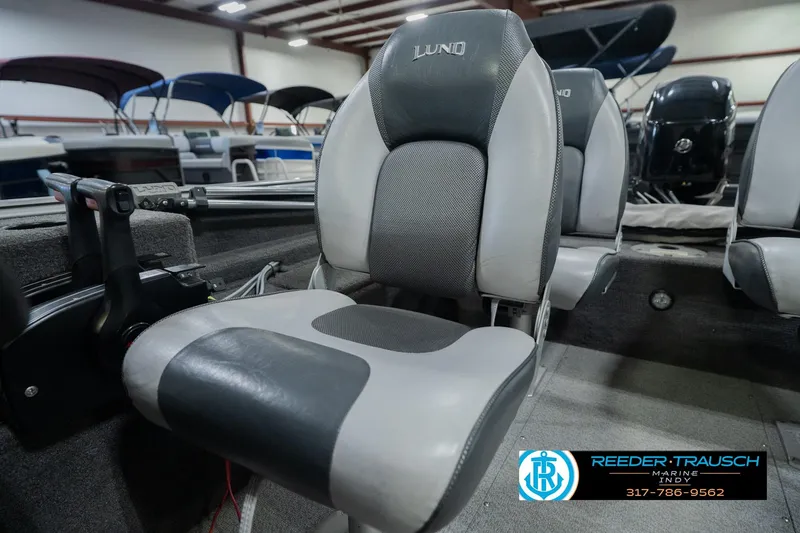 Slide: The Image of 2013 Lund 1650 Rebel XL Sport boat interior with gray seating in showroom. - 32