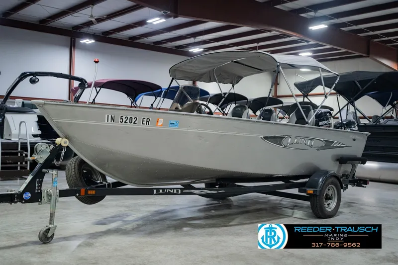 Slide: The Image of 2013 Lund 1650 Rebel XL Sport boat on trailer in indoor showroom. - 4