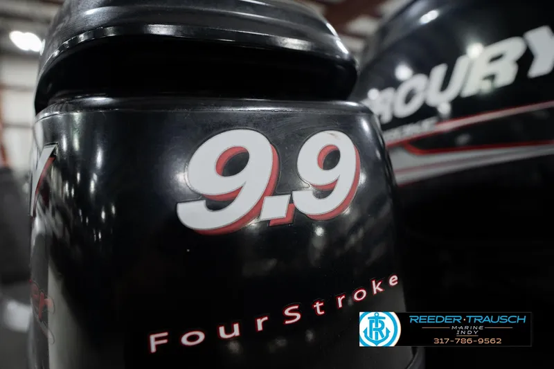 Slide: The Image of 9.9 horsepower four-stroke outboard motor close-up, Reeder-Trausch Marine logo visible. - 43