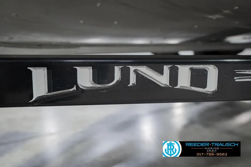 Slide: The Image of Close-up of 2013 Lund 1650 Rebel XL Sport boat logo on black surface. - 49