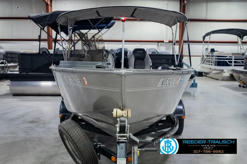 Slide: The Image of 2013 Lund 1650 Rebel XL Sport boat on trailer in indoor showroom. - 5