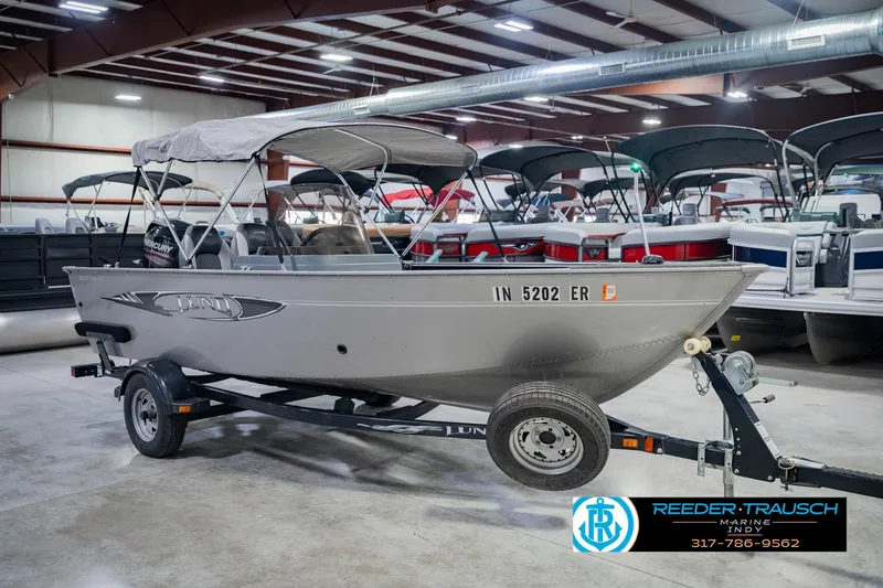 Slide: The Image of 2013 Lund 1650 Rebel XL Sport boat on trailer in showroom. - 6