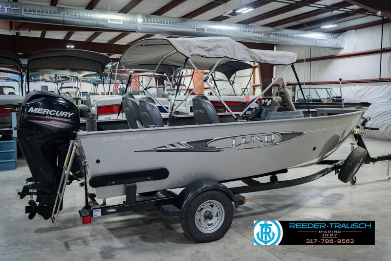 Slide: The Image of 2013 Lund 1650 Rebel XL Sport boat with Mercury engine in showroom. - 8