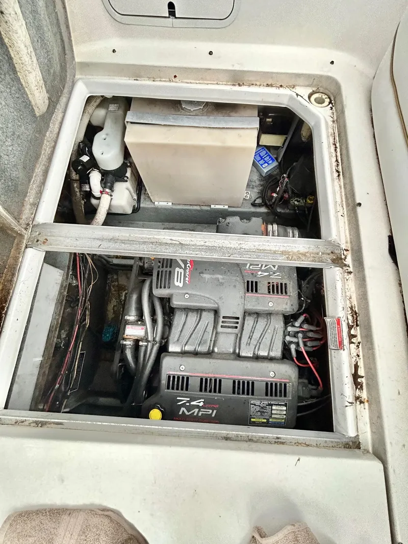 Slide: The Image of Engine compartment of a 1999 Sea Ray 270 Sundancer boat, featuring a 7.4 MPI engine. - 19