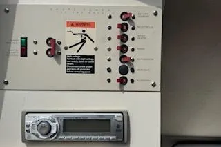 Slide: The Image of Control panel of a 2001 Maxum 2400 SCR boat with switches and stereo system. - 12