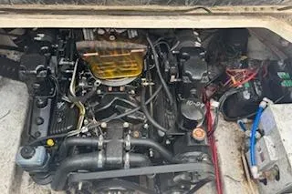 Slide: The Image of Engine compartment of a 2001 Maxum 2400 SCR boat, showcasing mechanical components and wiring. - 14