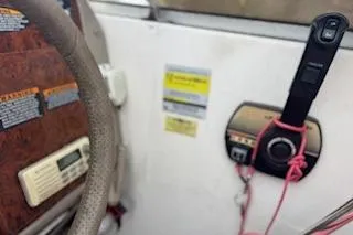 Slide: The Image of 2001 Maxum 2400 SCR boat dashboard with steering wheel and control panel. - 5