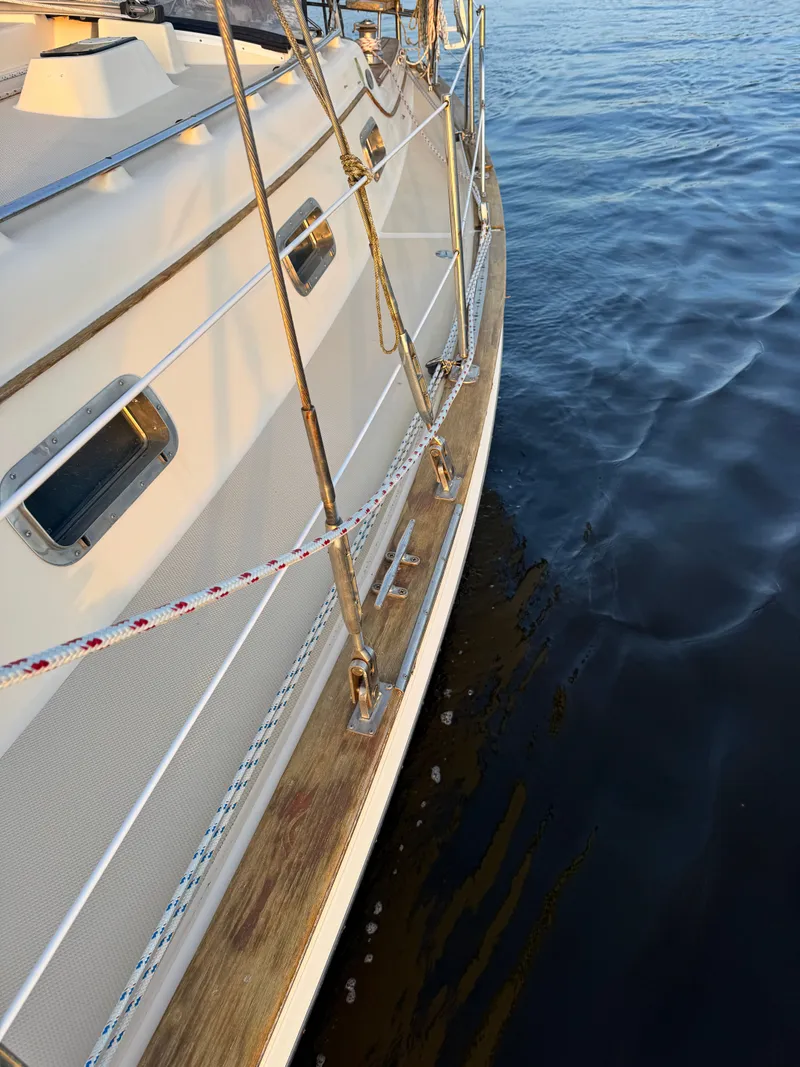 Slide: The Image of Side view of a 2001 Island Packet 380 yacht on calm water. - 14