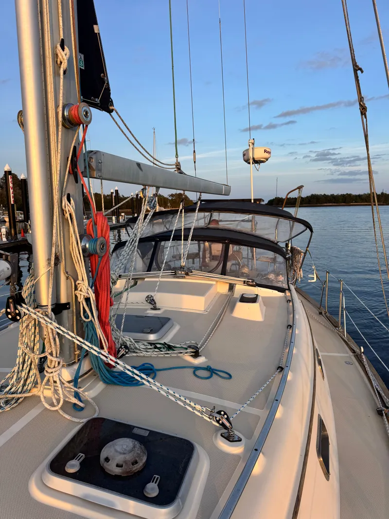 Slide: The Image of 2001 Island Packet 380 sailboat on calm water at sunset. - 18