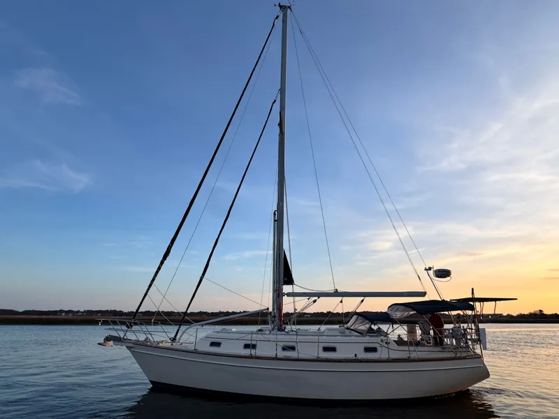 Slide: The Image of 2001 Island Packet 380 sailboat on water at sunset. - 19