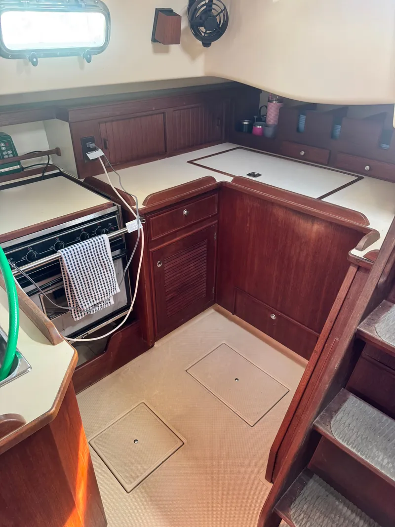 Slide: The Image of Interior of 2001 Island Packet 380 yacht featuring kitchen area. - 26