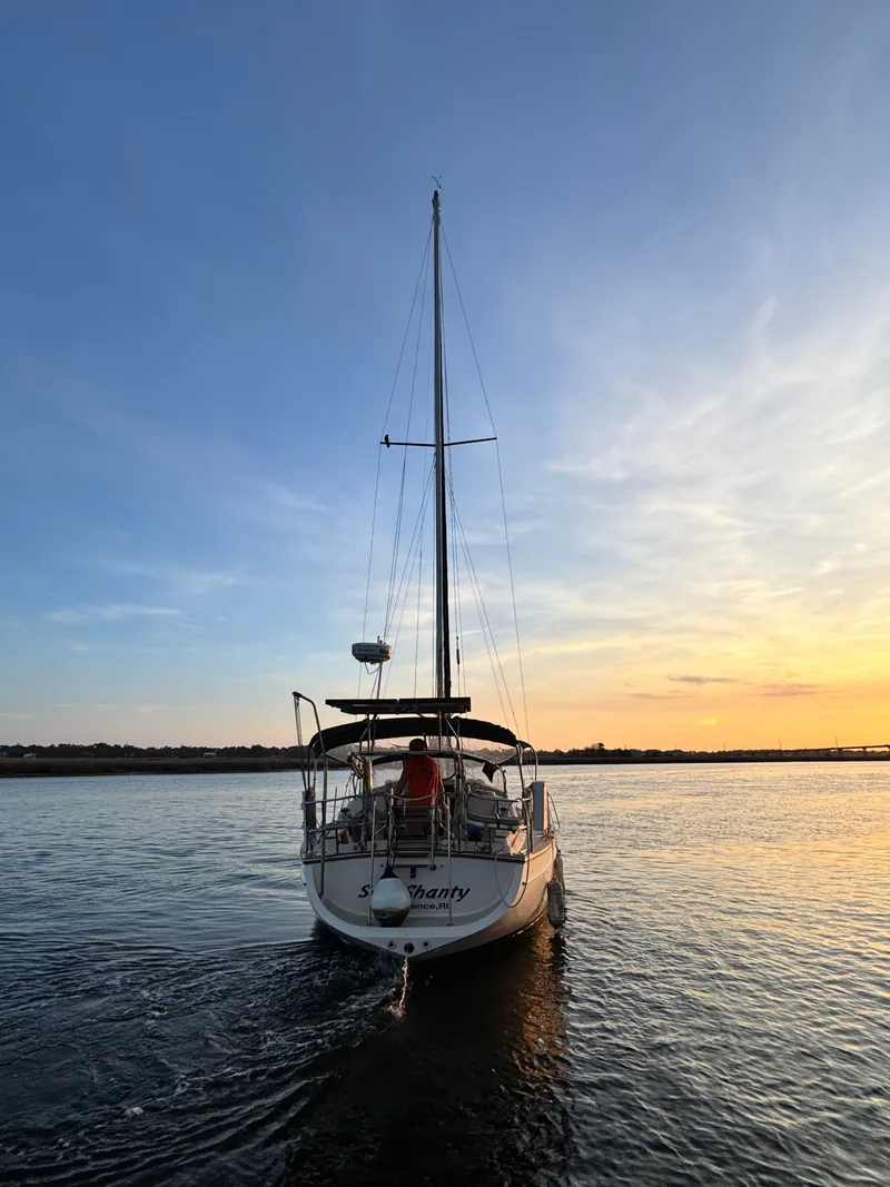Slide: The Image of Island Packet 380 sailboat at sunset on calm waters, year 2001. - 4