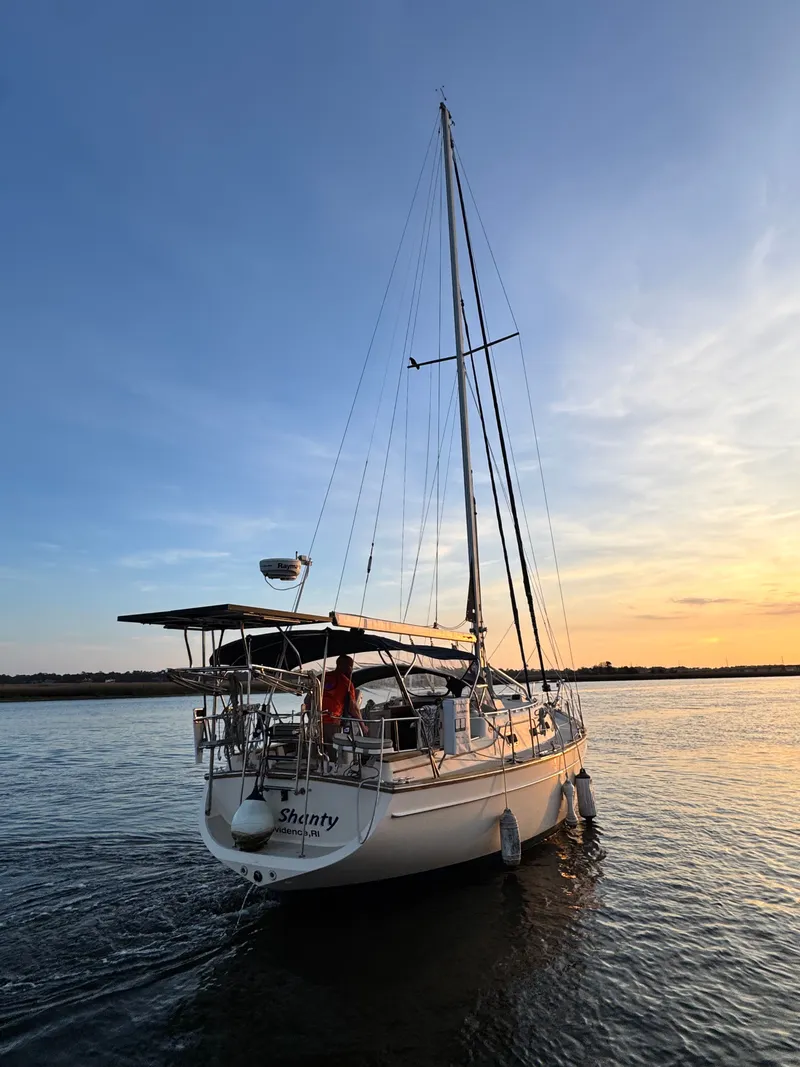 Slide: The Image of 2001 Island Packet 380 sailboat on water at sunset. - 5