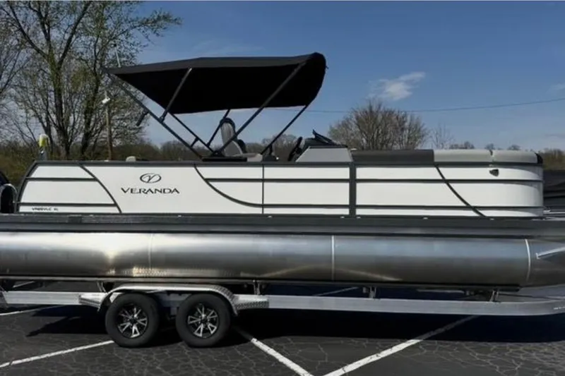 Slide: The Image of 2025 Veranda Relax VR25VLC pontoon boat on trailer, featuring sleek design and canopy. - 4
