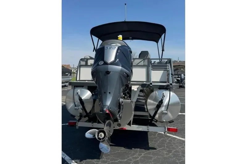 Slide: The Image of 2025 Veranda Relax VR25VLC pontoon boat with powerful outboard motor, parked outdoors. - 7