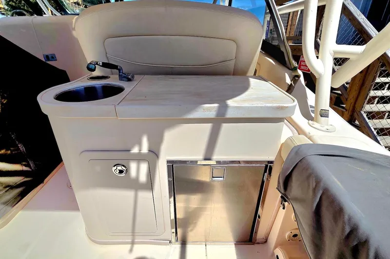 Slide: The Image of 2015 Grady-White Freedom 307 boat interior with sink and storage area. - 13