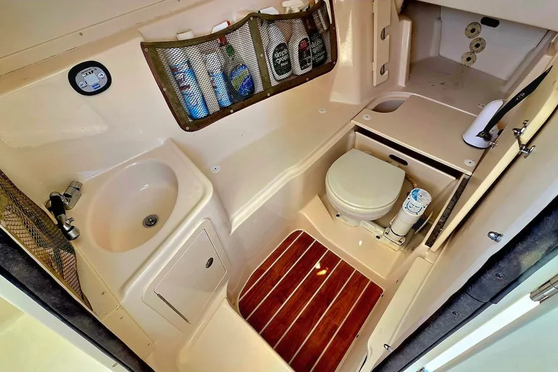 Slide: The Image of 2015 Grady-White Freedom 307 boat bathroom with sink, toilet, and storage. - 15