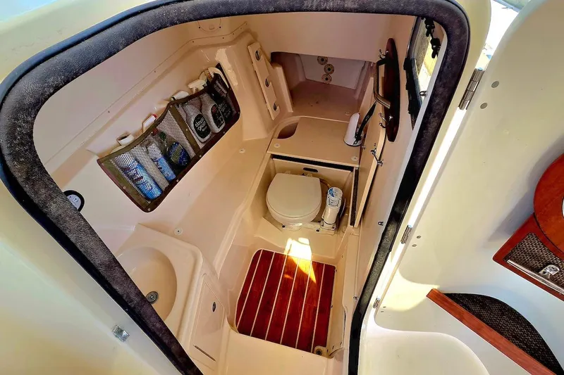 Slide: The Image of 2015 Grady-White Freedom 307 boat interior with compact bathroom amenities. - 16