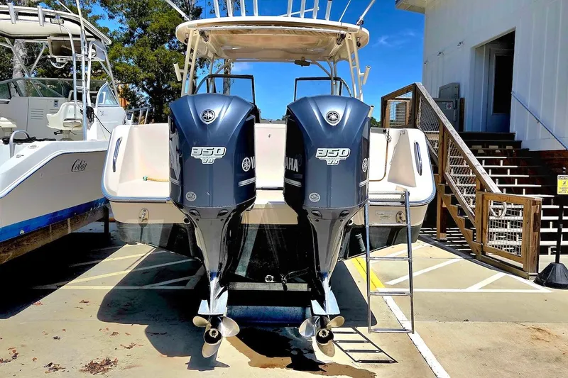 Slide: The Image of 2015 Grady-White Freedom 307 boat with twin Yamaha 350 engines at dockside. - 18