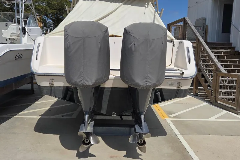 Slide: The Image of 2015 Grady-White Freedom 307 boat with covered dual outboard motors, docked outdoors. - 19
