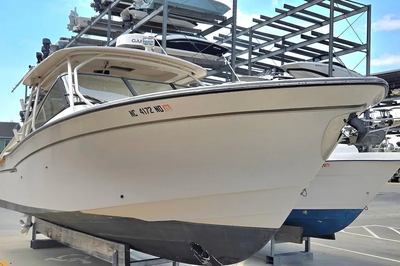 Slide: The Image of 2015 Grady-White Freedom 307 boat in storage, showcasing sleek design and sturdy build. - 3