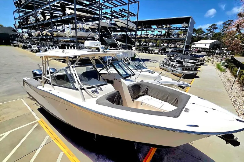 Slide: The Image of 2015 Grady-White Freedom 307 boat in a marina with stacked boats in background. - 4