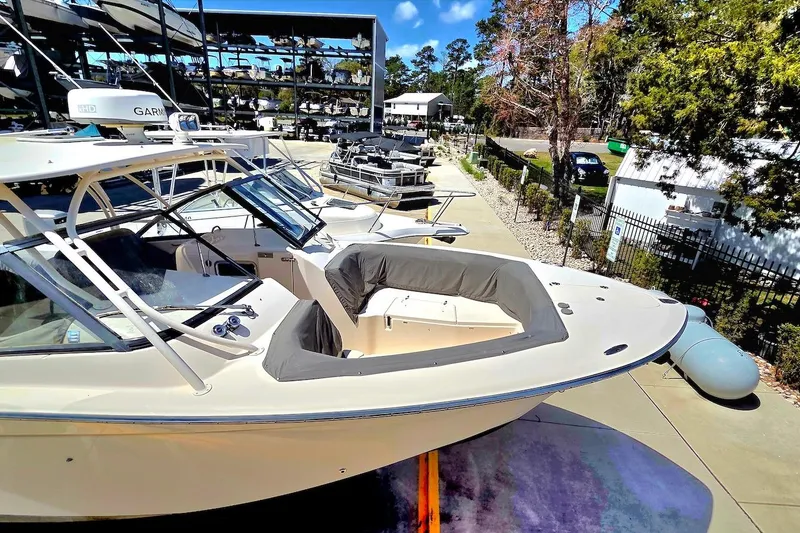Slide: The Image of 2015 Grady-White Freedom 307 boat docked, showcasing sleek design and spacious seating. - 5