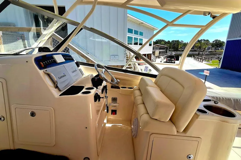 Slide: The Image of 2015 Grady-White Freedom 307 boat interior with steering wheel and Garmin navigation system. - 6