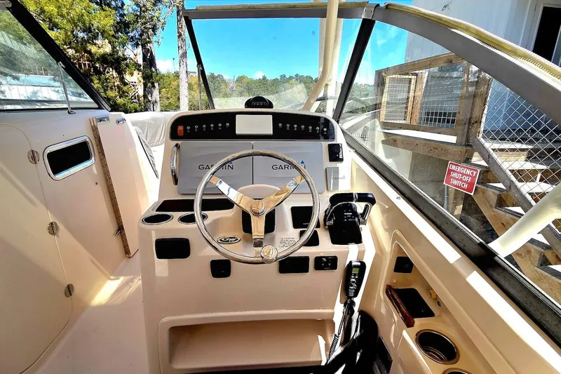 Slide: The Image of 2015 Grady-White Freedom 307 boat cockpit with steering wheel and Garmin navigation system. - 7