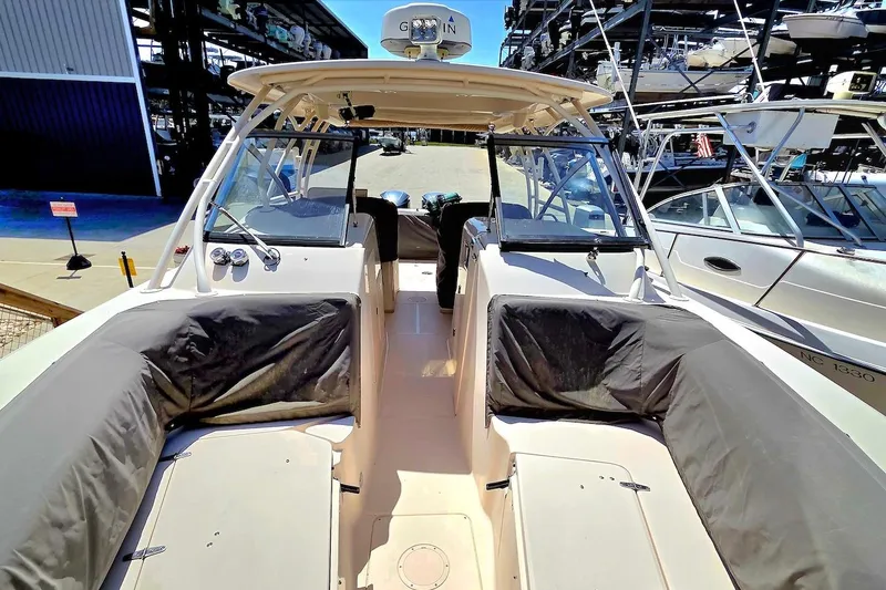 Slide: The Image of 2015 Grady-White Freedom 307 boat interior with seating and helm, docked at marina. - 9