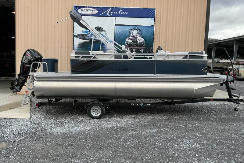 The Image of 2026 Avalon Venture Quad Lounge 21' pontoon boat on trailer, displayed outdoors. - 1
