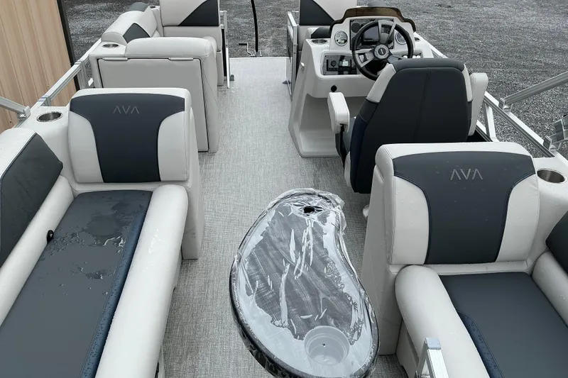 Slide: The Image of 2026 Avalon Venture Quad Lounge boat interior with plush seating and modern helm. - 10