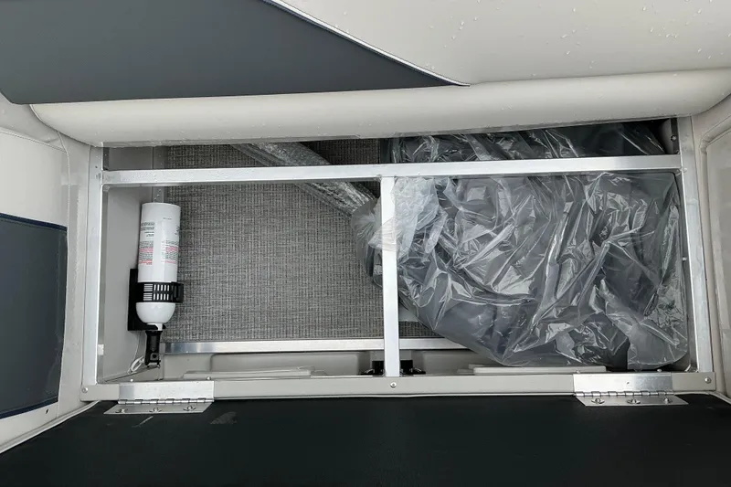 Slide: The Image of Storage compartment of 2026 Avalon Venture Quad Lounge boat, featuring organized interior space. - 6