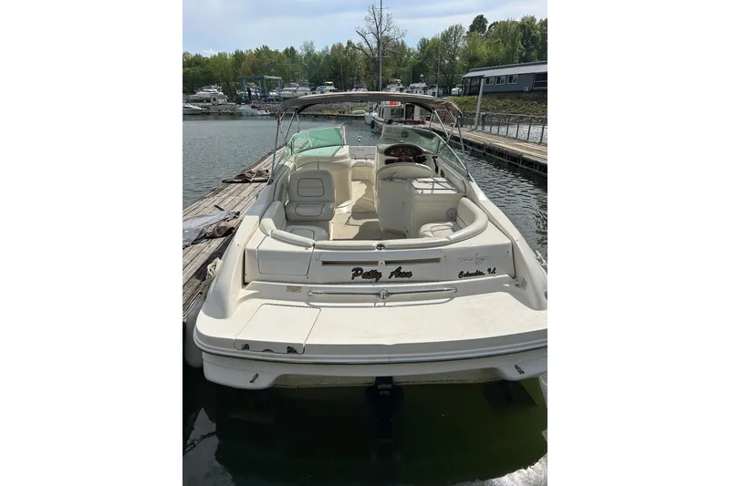 Slide: The Image of 1998 Sea Ray 280 Bow Rider docked at a marina, featuring spacious seating and sleek design. - 17