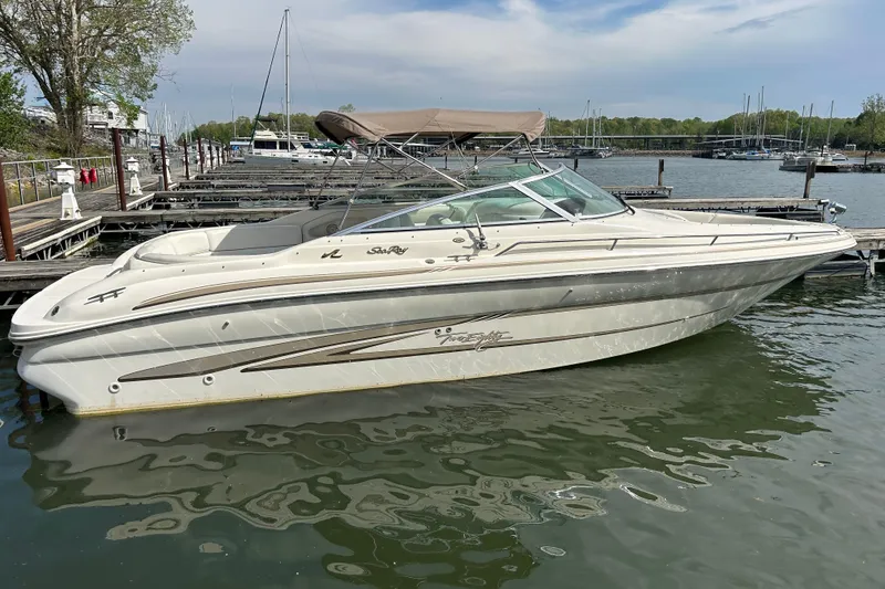 Slide: The Image of 1998 Sea Ray 280 Bow Rider boat docked at a marina on a sunny day. - 24
