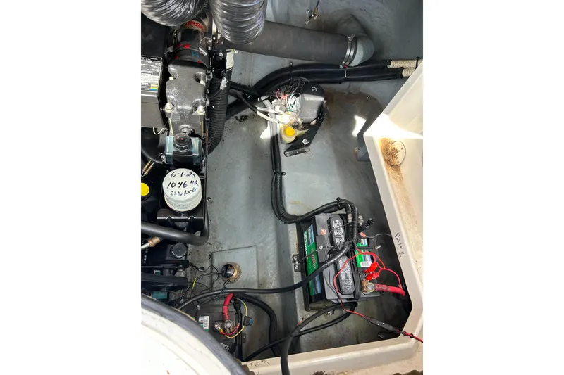 Slide: The Image of Engine compartment of a 1998 Sea Ray 280 Bow Rider with visible battery and wiring. - 35