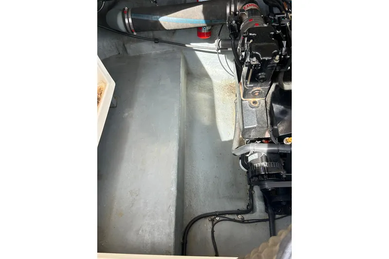 Slide: The Image of Engine compartment of a 1998 Sea Ray 280 Bow Rider boat, showing mechanical components. - 36