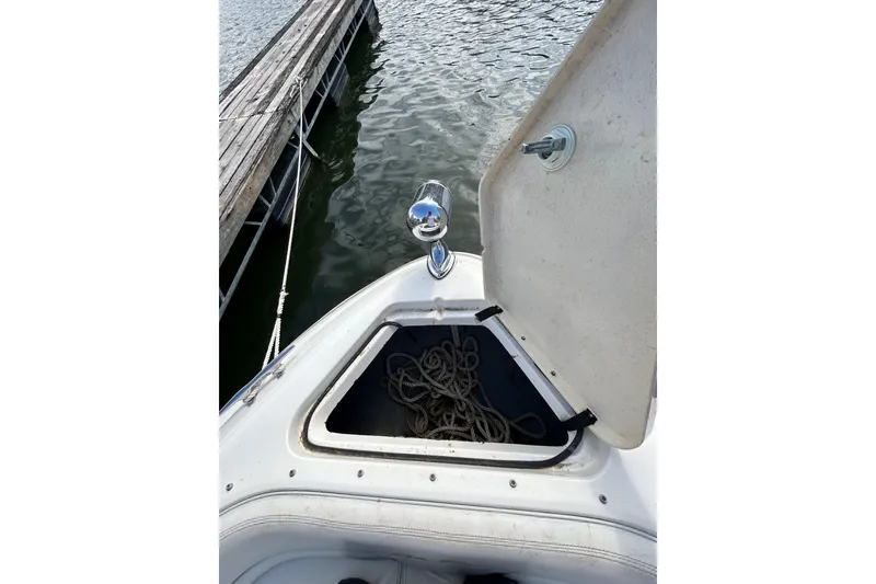 Slide: The Image of Open storage compartment on 1998 Sea Ray 280 Bow Rider boat with rope inside. - 46