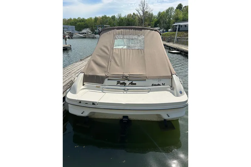 Slide: The Image of 1998 Sea Ray 280 Bow Rider docked with tan cover, rear view. - 50