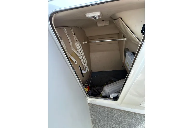 Slide: The Image of 1998 Sea Ray 280 Bow Rider storage compartment with ropes and equipment. - 54