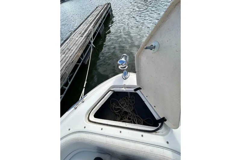 Slide: The Image of Open storage compartment on 1998 Sea Ray 280 Bow Rider boat, dockside view. - 65