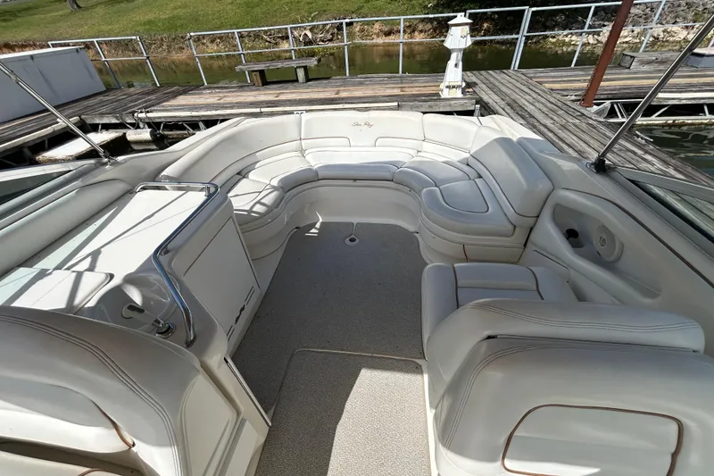 Slide: The Image of 1998 Sea Ray 280 Bow Rider interior with white seating and spacious layout. - 68