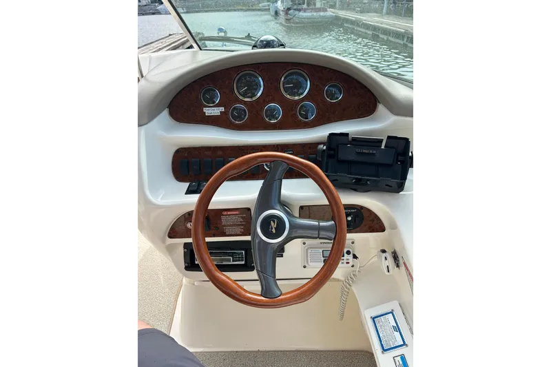 Slide: The Image of 1998 Sea Ray 280 Bow Rider dashboard with wooden steering wheel and instrument panel. - 71